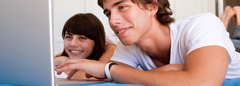 Teenage couple using laptop